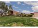 Well kept front lawn with mature trees surrounds the building, showing the community's green space at 3871 Sinclair St, Las Vegas, NV 89121