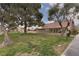 A well manicured lawn with mature trees surrounding a well maintained home at 3871 Sinclair St, Las Vegas, NV 89121