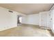 Bright living area showcasing an open floor plan, natural light, and neutral colored carpet at 3871 Sinclair St, Las Vegas, NV 89121