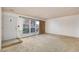 A spacious living room with a large window and neutral carpet, awaiting personal touches at 3871 Sinclair St, Las Vegas, NV 89121
