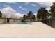 A community pool with a large deck area, several trees, and a clear blue sky at 3871 Sinclair St, Las Vegas, NV 89121
