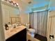 Neutral bathroom featuring a light vanity with a neutral patterned shower curtain and wood detailing at 4046 Sparrow Rock St, Las Vegas, NV 89129