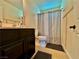Cozy bathroom featuring a dark vanity with a neutral shower curtain and modern design at 4046 Sparrow Rock St, Las Vegas, NV 89129