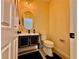 Stylish powder room featuring a black vanity with gold trim and oval mirror at 4046 Sparrow Rock St, Las Vegas, NV 89129