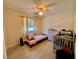 Cozy bedroom with ceiling fan, wood-look floors, natural light, and comfortable furnishings at 4046 Sparrow Rock St, Las Vegas, NV 89129