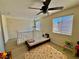 Bedroom features a single bed, ceiling fan, and laminate wood flooring at 4046 Sparrow Rock St, Las Vegas, NV 89129