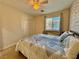 Bright bedroom featuring a ceiling fan, natural light, closet, and neutral color palette at 4046 Sparrow Rock St, Las Vegas, NV 89129