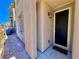 Close-up of a front entrance featuring a decorative light fixture, doormat, and well-kept brick walkway at 4046 Sparrow Rock St, Las Vegas, NV 89129