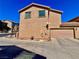 Two-story home featuring a two-car garage, neutral-toned stucco, a red-tiled roof and a desert landscape at 4046 Sparrow Rock St, Las Vegas, NV 89129