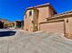 Two-story home featuring a two-car garage, neutral-toned stucco, and a red-tiled roof, with a desert landscape at 4046 Sparrow Rock St, Las Vegas, NV 89129