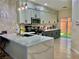 Modern kitchen with white upper cabinets, dark lower cabinets, quartz countertops, and a peninsula island at 4046 Sparrow Rock St, Las Vegas, NV 89129