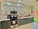 Bright kitchen with modern appliances, quartz countertops, and convenient access to the backyard at 4046 Sparrow Rock St, Las Vegas, NV 89129