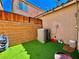 Enclosed patio space with artificial grass, string lights, and brick walls at 4046 Sparrow Rock St, Las Vegas, NV 89129