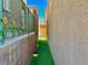 Artificial turf in a side yard with a brick wall on a sunny day at 4046 Sparrow Rock St, Las Vegas, NV 89129
