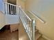 Bright staircase featuring wood treads, white risers, and a white handrail at 4046 Sparrow Rock St, Las Vegas, NV 89129