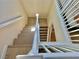 Bright staircase with white railing leading to upper floor, showcasing wood floors at 4046 Sparrow Rock St, Las Vegas, NV 89129