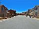 Street view of suburban homes with well-maintained landscaping on a clear, sunny day at 4046 Sparrow Rock St, Las Vegas, NV 89129
