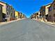 Straight street view of suburban homes on a clear day at 4046 Sparrow Rock St, Las Vegas, NV 89129
