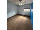 This bedroom features light blue walls, tan carpet, and a window with shade at 4239 White Sands Ave, Las Vegas, NV 89121