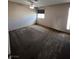 This bedroom has tan walls, tan carpet, two windows, and a ceiling fan at 4239 White Sands Ave, Las Vegas, NV 89121