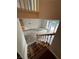 A view looking down the staircase into the bright open-concept living room at 4239 White Sands Ave, Las Vegas, NV 89121