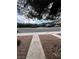 Street view of the property showing the road, sidewalk, and minimal landscaping at 4239 White Sands Ave, Las Vegas, NV 89121