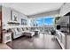 Modern living room featuring a gray sectional sofa, hard wood floors, and a large window with a city view at 4471 Dean Martin Dr # 2204, Las Vegas, NV 89103