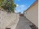 A view down the side of the home to a backyard with a block perimeter fence at 4562 Scott Ave, Las Vegas, NV 89102