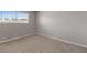 This bedroom features neutral carpet and a window allowing for natural light at 4562 Scott Ave, Las Vegas, NV 89102
