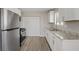 Bright kitchen with stainless steel appliances, granite countertops, and ample cabinet space at 4562 Scott Ave, Las Vegas, NV 89102
