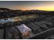 Sweeping aerial perspective of a luxury home nestled in a community with a golf course and lake at sunset at 51 Reflection Cove Dr, Henderson, NV 89011