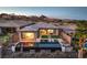 View of a backyard featuring a modern pool, an outdoor living area, and well-maintained landscaping at 51 Reflection Cove Dr, Henderson, NV 89011