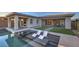 Beautiful backyard oasis featuring a pool with built-in loungers and lush landscaping at 51 Reflection Cove Dr, Henderson, NV 89011