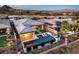 Aerial shot of a backyard with an inviting pool, a cozy outdoor area, and lush landscaping at 51 Reflection Cove Dr, Henderson, NV 89011