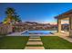 Stunning backyard with a luxurious pool, landscaped garden, and beautiful mountain views at 51 Reflection Cove Dr, Henderson, NV 89011