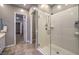 Bathroom with a large glass enclosed shower and access to the main bedroom and walk-in closet at 51 Reflection Cove Dr, Henderson, NV 89011