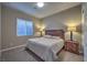 Comfortable bedroom featuring a plush bed, stylish lamps, and soft carpeting at 51 Reflection Cove Dr, Henderson, NV 89011