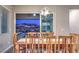 Dining room with mountain views, wood table with seating for eight, and modern chandelier at 51 Reflection Cove Dr, Henderson, NV 89011