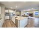 Open concept kitchen with a large island, stainless steel appliances, and hardwood floors at 51 Reflection Cove Dr, Henderson, NV 89011