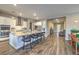 Contemporary kitchen with granite island, stainless steel appliances, and hardwood floors throughout at 51 Reflection Cove Dr, Henderson, NV 89011