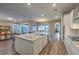 Spacious kitchen with an oversized island, barstool seating, stainless steel appliances, and hardwood floors at 51 Reflection Cove Dr, Henderson, NV 89011