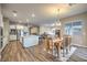 Open concept kitchen, dining, and living area with hard surface floors and modern decor at 51 Reflection Cove Dr, Henderson, NV 89011