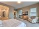 Relaxing main bedroom with neutral decor, backyard views, and comfortable seating at 51 Reflection Cove Dr, Henderson, NV 89011