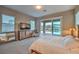Bright main bedroom with backyard views, neutral carpet, and wooden furniture accents at 51 Reflection Cove Dr, Henderson, NV 89011