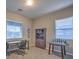 Bright home office with natural light, desk, bookcase, and a game table for entertainment at 51 Reflection Cove Dr, Henderson, NV 89011