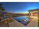 A luxurious infinity pool offers stunning views of the city lights and surrounding mountains at twilight at 51 Reflection Cove Dr, Henderson, NV 89011