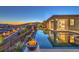 This backyard has a beautiful pool, fire pit, and mountain views with a bedroom visible through the glass door at 51 Reflection Cove Dr, Henderson, NV 89011