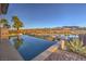 Infinity pool overlooking a scenic mountain and lake view with desert landscaping at 51 Reflection Cove Dr, Henderson, NV 89011