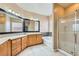 Bathroom featuring double sinks, a soaking tub, and a glass-enclosed shower at 5505 Criollo Dr, Las Vegas, NV 89122