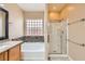 Bright bathroom with a soaking tub, glass-enclosed shower, and tile flooring at 5505 Criollo Dr, Las Vegas, NV 89122